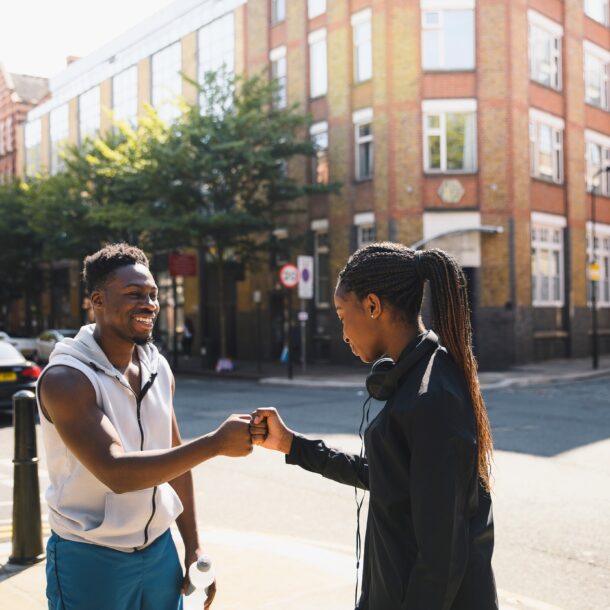 Two friends fist bumping