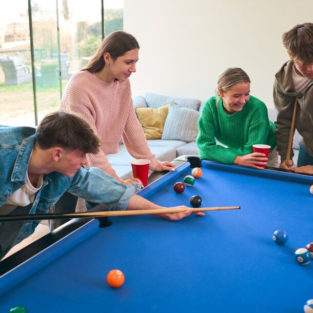 A group of young people playing pool