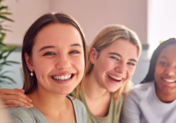 Group of teenage female friends laughing together