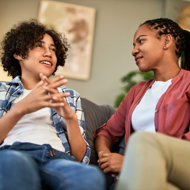 Young person talking to support worker on the sofa